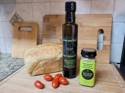 Foodie Gift Set microgreens seasoning and infused avocado oil on cutting board by Eat Your Greens